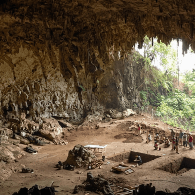 Explorers inside the limestone cave complex and temple at Batatotalena Sri Lanka