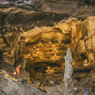 Explorers wading through an underground river in the Tu Lan Cave System Vietnam