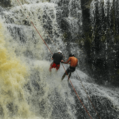 Adventurer abseiling down a waterfall during a canyoning trip in Đà Lạt Vietnam